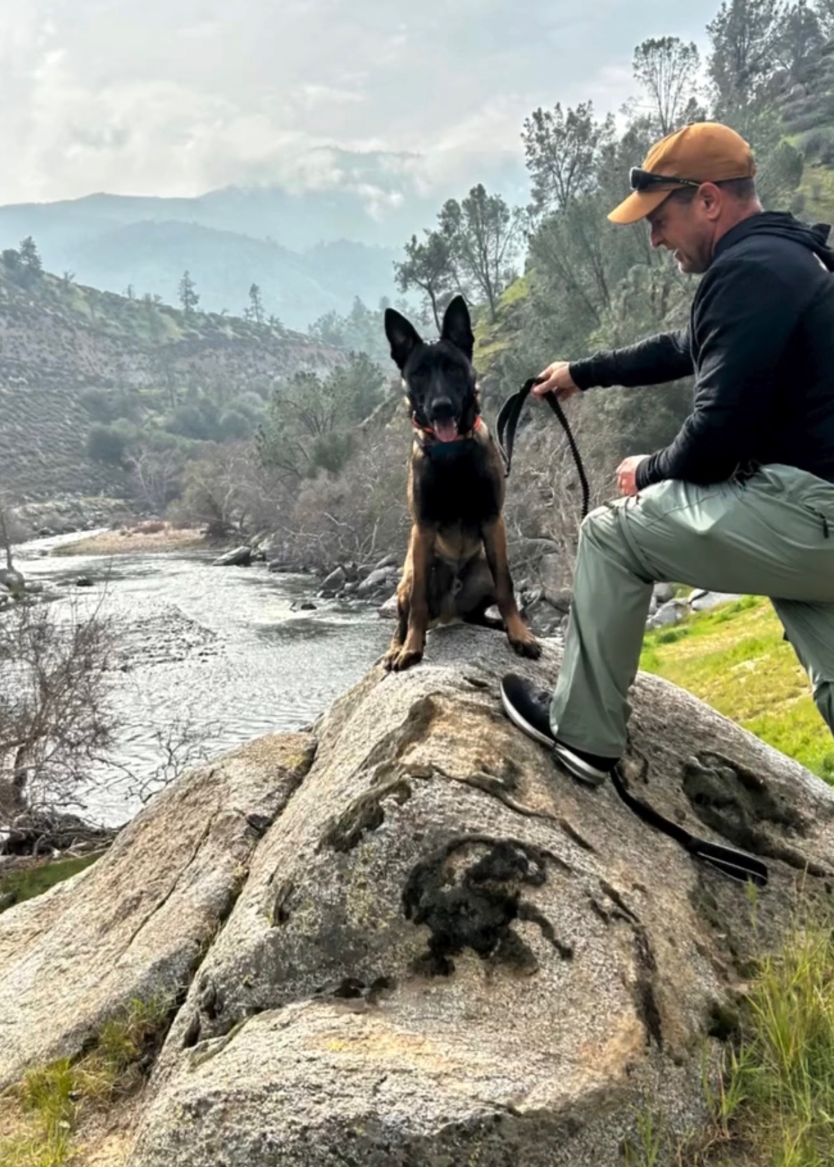 Dusty Paws K9 trainer with dog overlooking Kern River